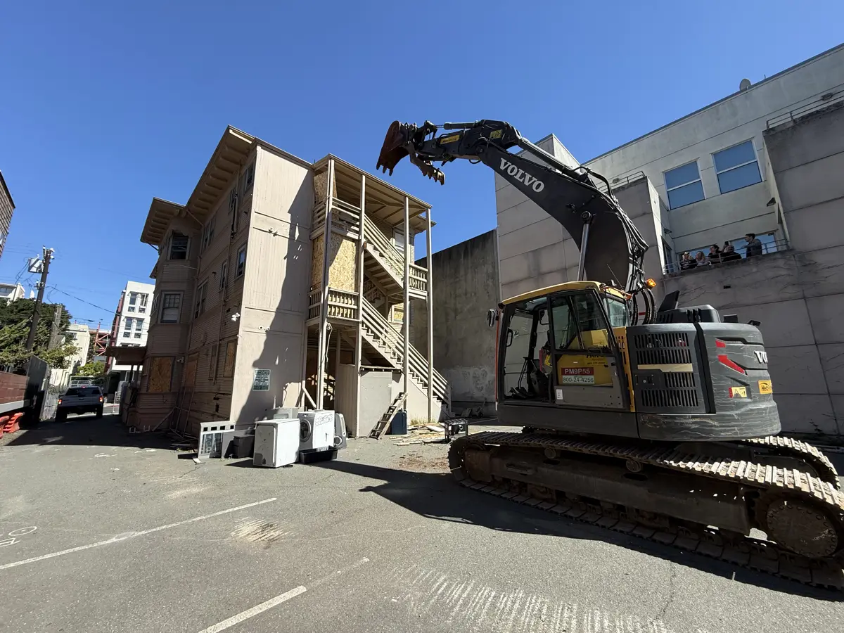 Excavator clearing a demolition site